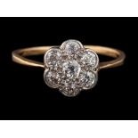 A 1920s diamond cluster ring,: set with old brilliant cut diamonds, approximately 0.