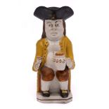 A small Pratt pearlware toby jug: holding a foaming jug in his left hand, a goblet in his right,