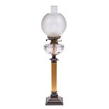 A Victorian brass oil lamp: with clear glass reservoir, on a fluted column and stepped bronze base,