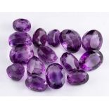 Fifteen unset amethysts,: the oval and circular cut amethysts, approximately 127.00 carats total.