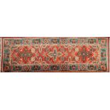 An Iranian runner:, the brick red field with triple geometric flowerhead medallions,