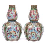A pair of Chinese Canton double gourd famille rose vases: the necks relief moulded with turquoise