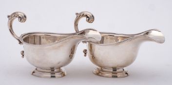 A pair of George VI silver pedestal sauceboats, maker Harrods Ltd, London,