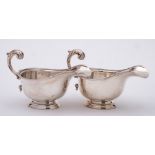 A pair of George VI silver pedestal sauceboats, maker Harrods Ltd, London,