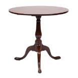 A George III mahogany circular tea table:, with a snap top on ring turned baluster column,