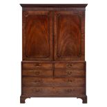 A George III mahogany linen press:, adapted as a gentleman's wardrobe,