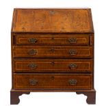 An early 18th Century walnut and cross and feather banded bureau:,