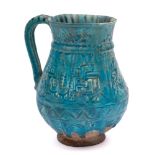 A Iranian possibly Kashan pottery mug: of bulbous form the body moulded in low relief with a band