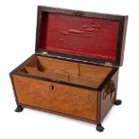 A Regency period burr maple and ebony strung tea caddy: of sarcophagus outline,