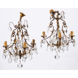 A pair of gilt metal and cut glass hung four-light chandeliers in Louis XV style,