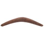 An Aboriginal boomerang: of traditional design , one side chip carved with lizard,