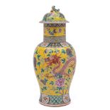 A Chinese famille rose yellow ground baluster vase and cover: with lion pup finial,