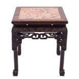 A Chinese hardwood stand with marble top: carved with scrolling foliage above a pierced freize,