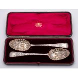 Two George III silver Old English pattern and later decorated berry spoons,