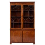 An Edwardian mahogany bookcase:, the upper part with a moulded dentil cornice,