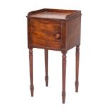 An early 19th Century mahogany pot cupboard:, with reeded edge and three quarter ledge gallery,