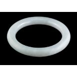 A jadeite bangle,: of plain polished form, 5.7cm inner diameter, 59g.