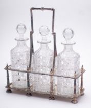 An Edwardian silver plated three decanter stand: of rectangular outline with beaded decoration and