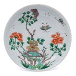 A Chinese famille verte saucer dish: painted with two butterflies flying above tree peonies issuing