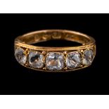 A 15 carat gold rock crystal ring,: set with five square cut rock crystals,
