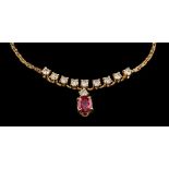 An 18 carat gold ruby and diamond necklace,: the oval cut ruby in a four claw setting,