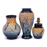 Two Moorcroft pottery vases and a matching lamp: each tube lined in the Honeycomb pattern after a