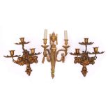 A pair of 19th century French gilt metal three-light wall appliques: with flared urn-shaped