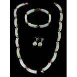 A jadeite necklace,: the polished curved panels of jadeite with belcher links in between,