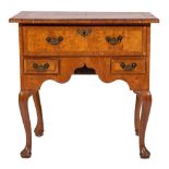 An early 18th Century walnut, oak and cross and feather banded lowboy:,