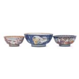 A group of three Chinese famille rose bowls: variously painted with panels of figures on lakeside