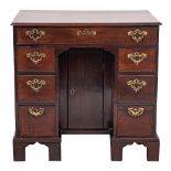 A mid 18th Century mahogany kneehole desk:, of small size, the top with a moulded edge,