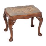 A 19th Century carved mahogany stool:, of serpentine outline in the George II taste,