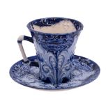 A William Moorcroft Macintyre Florian ware cup and saucer: of flared form with angular stalk handle,