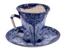 A William Moorcroft Macintyre Florian ware cup and saucer: of flared form with angular stalk handle,