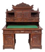 A Chinese carved wood pedestal desk:, with all over decoration of flowers, foliage,