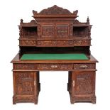 A Chinese carved wood pedestal desk:, with all over decoration of flowers, foliage,