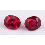 Two un-set rubies,: the oval cut rubies, stated to weigh 0.80 carats and 0.68 carats.