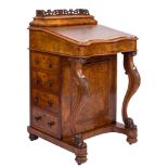 A Victorian walnut serpentine fronted davenport:,