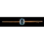 An aquamarine bar brooch,: the rectangular cut aquamarine in a claw setting,