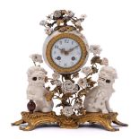 A Louis XV-style ormolu-mounted and blanc-de-chine porcelain mantel clock: with white enamel dial,