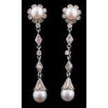 A pair of cultured pearl and diamond mounted pendant drop earrings: each with a cultured pearl