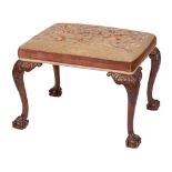 A carved mahogany frame rectangular stool in the George II taste:,