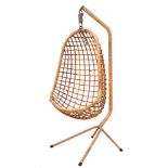 A late 20th Century bamboo swing chair on stand: the 'egg' shaped seat suspended from a bamboo