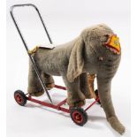 A mid 20th century Merrythought 'Shilpa' plush Indian elephant on wheels,