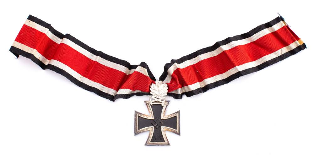 A Third Reich period Knights Cross: with replica oak leaves and swords.