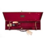 A brown leather gun case by Cogswell & Harrison,