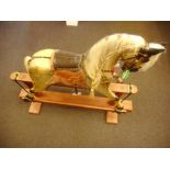 A 20th century rocking horse: inset glass eyes with open mouth and teeth, applied mane and tail,