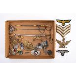 A collection of various military buttons and badges: including two sea mine badges,