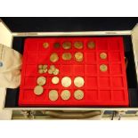A folder containing a small group of Roman coins,: two Sinking of the Lusitania medallions,