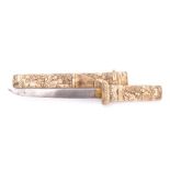 A 19th century tanto in carved bone scabbard: the short single edge blade with brass habaki over